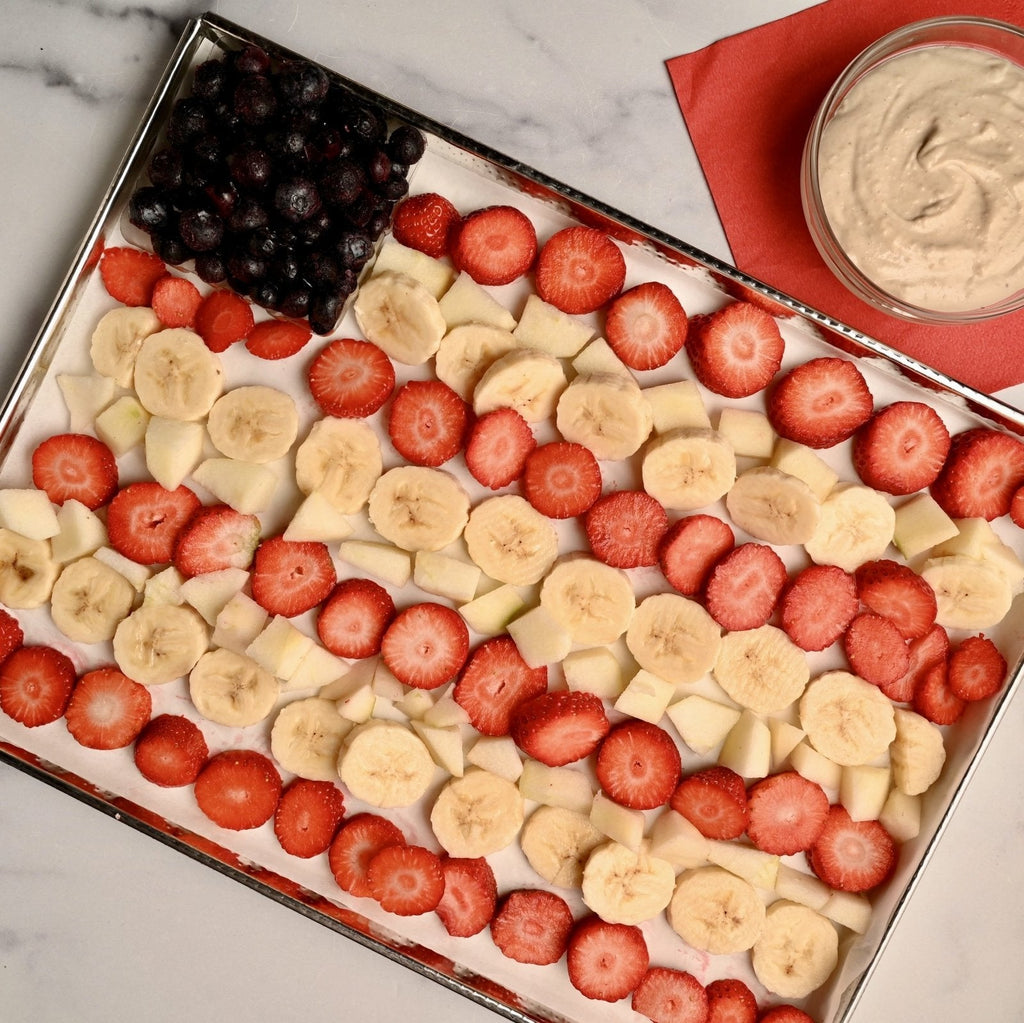 A sheet tray with fresh fruit on it in the shape of an American flag
