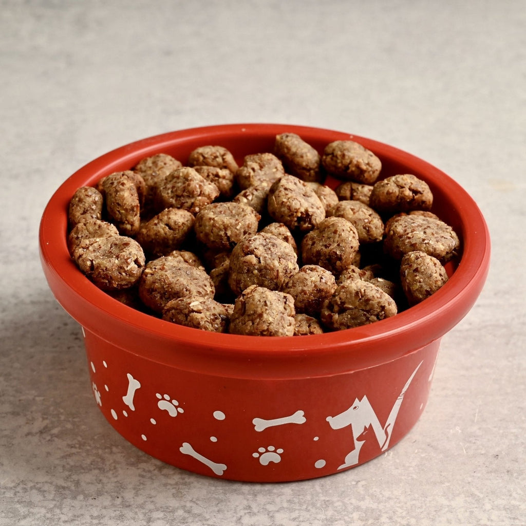 A red bowl filled with homemade dog bites