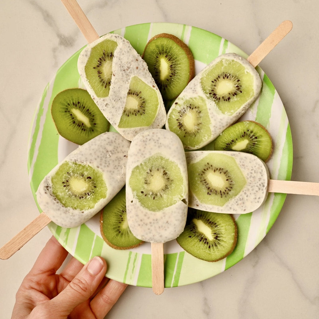 Kiwi popsicles with kiwi fruit slices on a serving plate