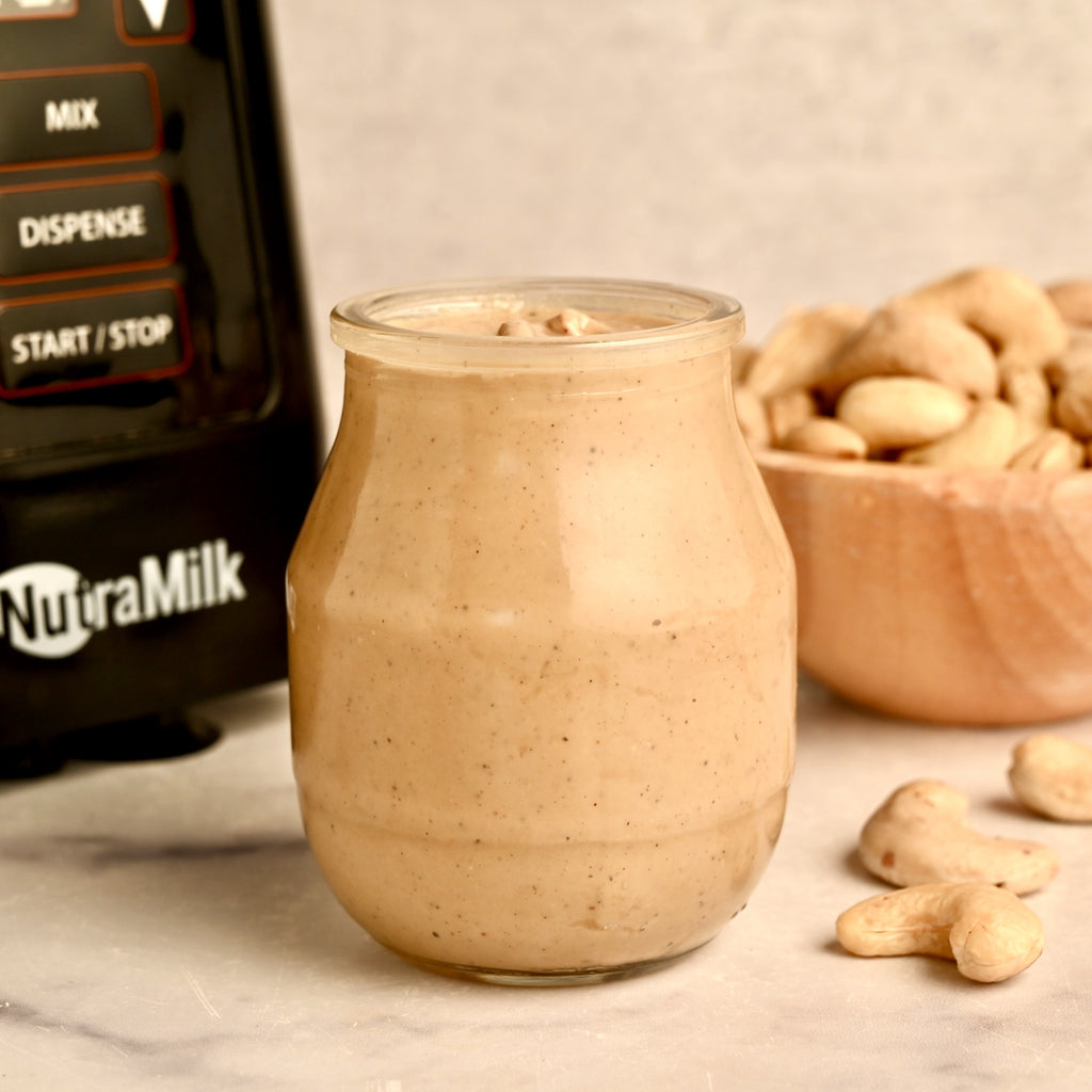 A clear glass jar filled with cashew butter