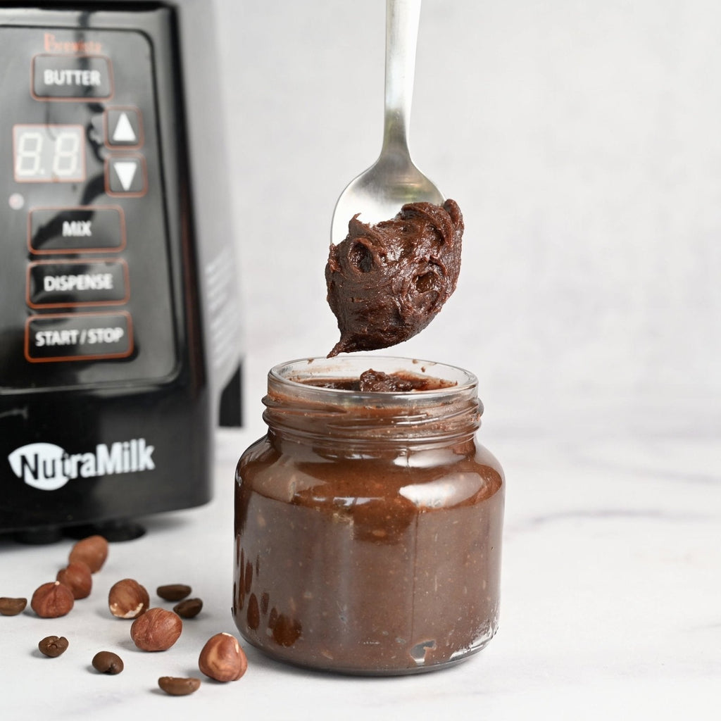 Small clear glass jar filled with chocolate hazelnut spread with a spoon scooping out a small tablespoon of it