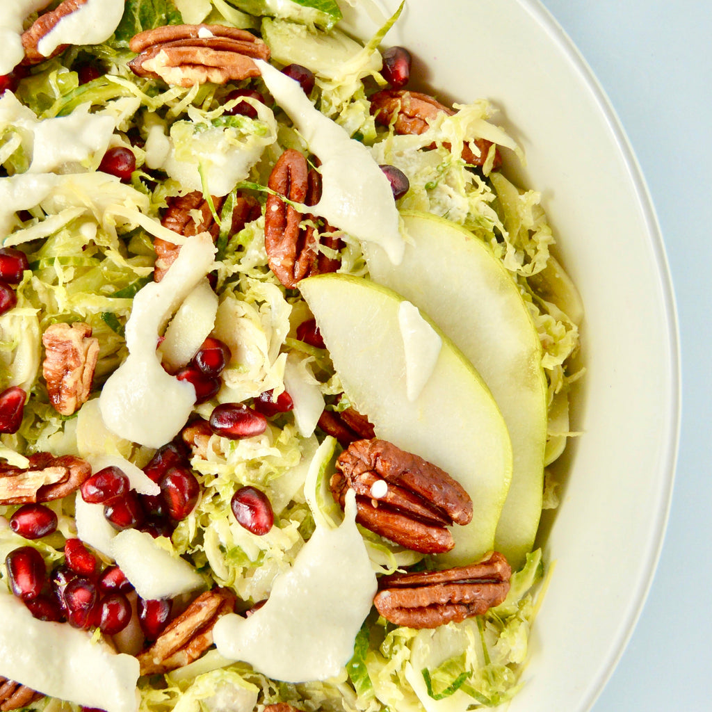 Brussel Sprout Salad With Pomegranate, Candied Pecans And Lemon Cashew Dressing
