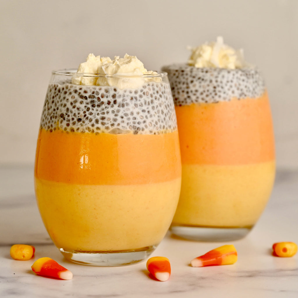 Candy corn chia pudding in two clear glasses