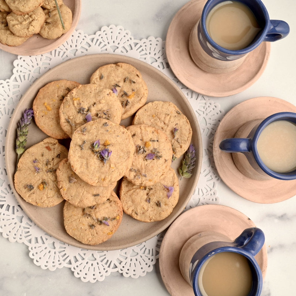 A plate of cookies with lavender sprinkled on top of them