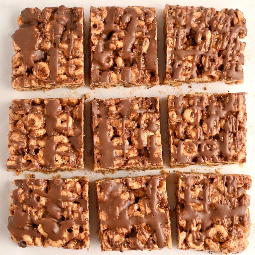 A plate of homemade Cheerio granola bars topped with a chocolate drizzle