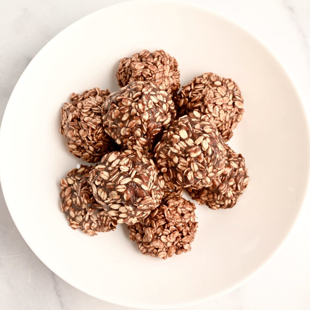 A white plate with homemade chocolate oat clusters laid out on it