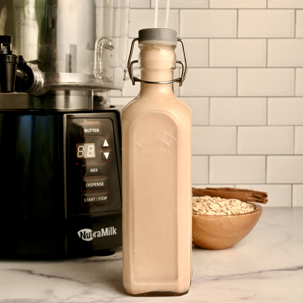 A large glass bottle filled with flavored oat milk