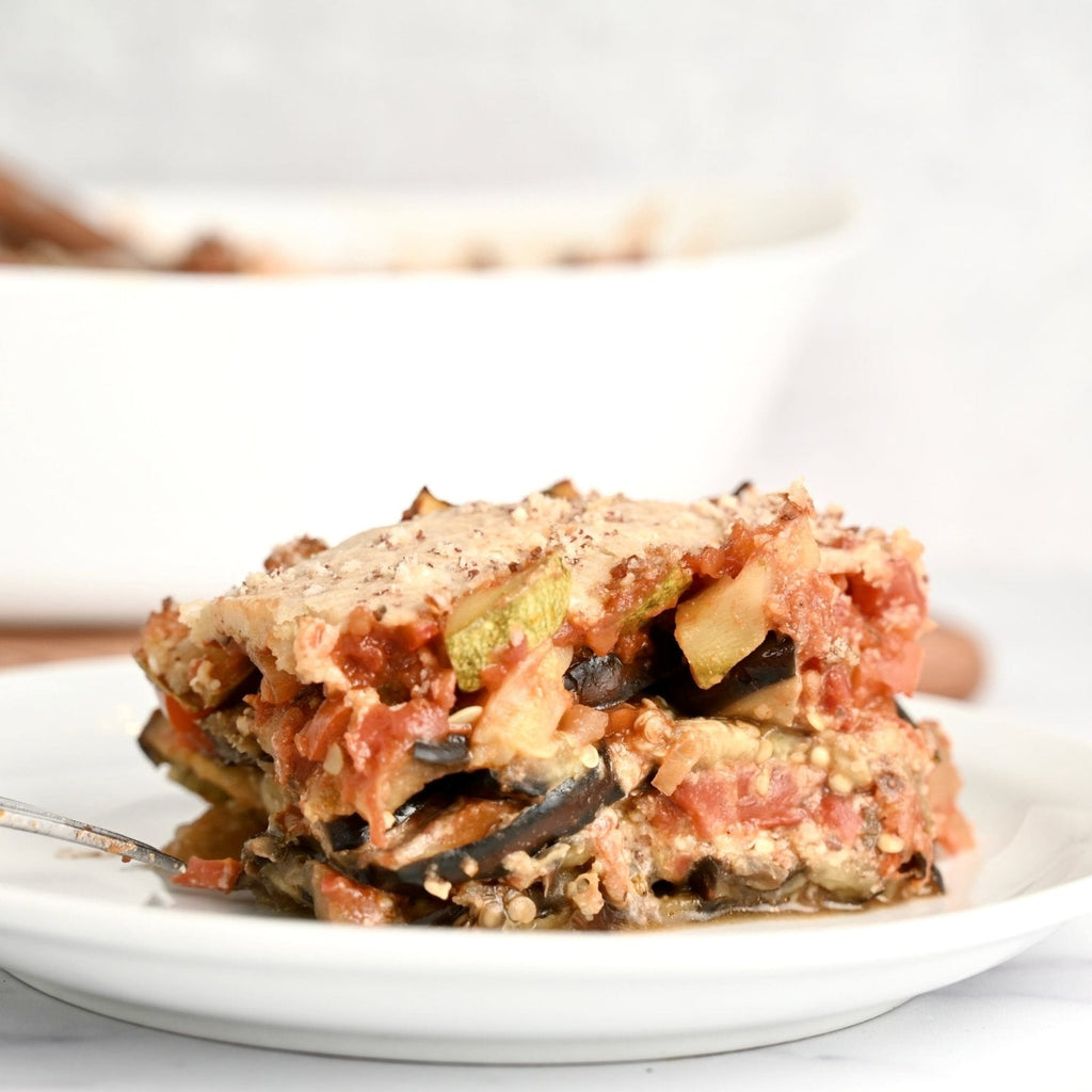 A white plant with a layered eggplant parmesan casserole