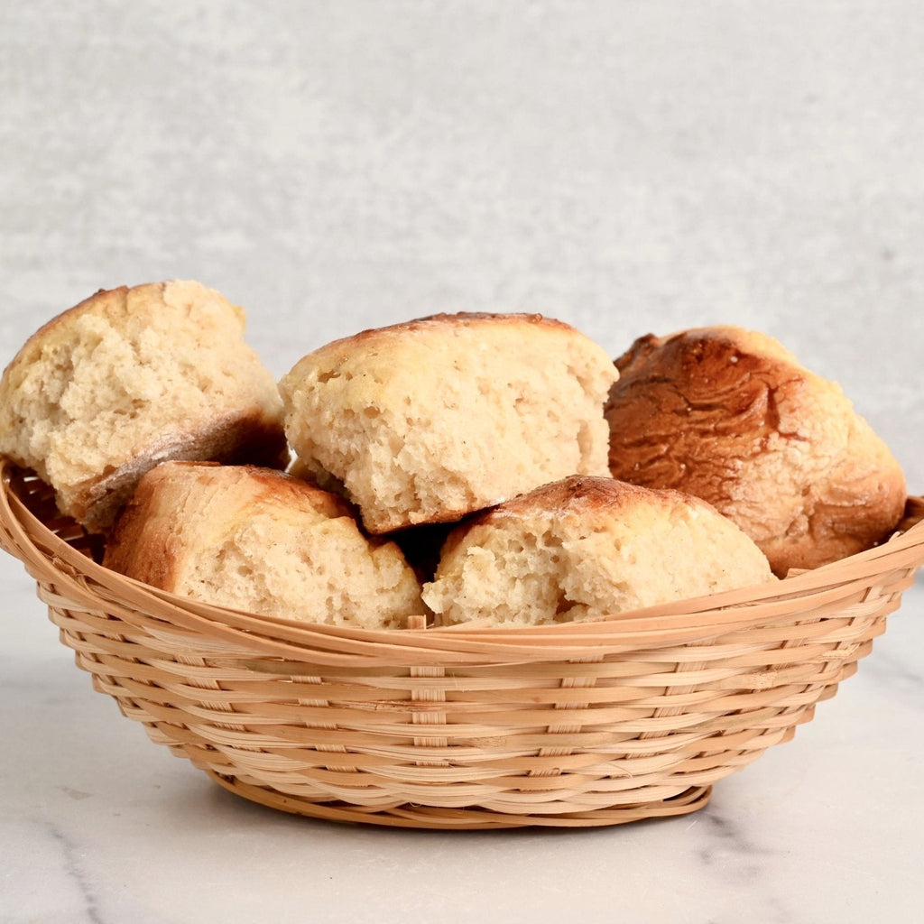 A wicker basket filled with homemade gluten free dinner rolls