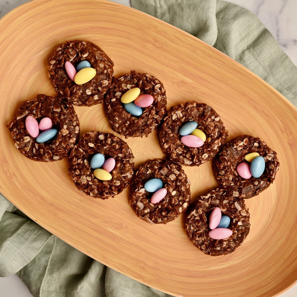 A tray with mini nest cookies filled with mini pastel colored chocolate eggs