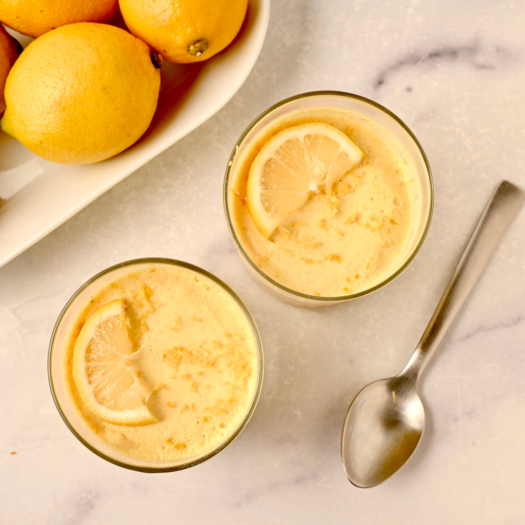 Two clear bowls filled with lemon mousse