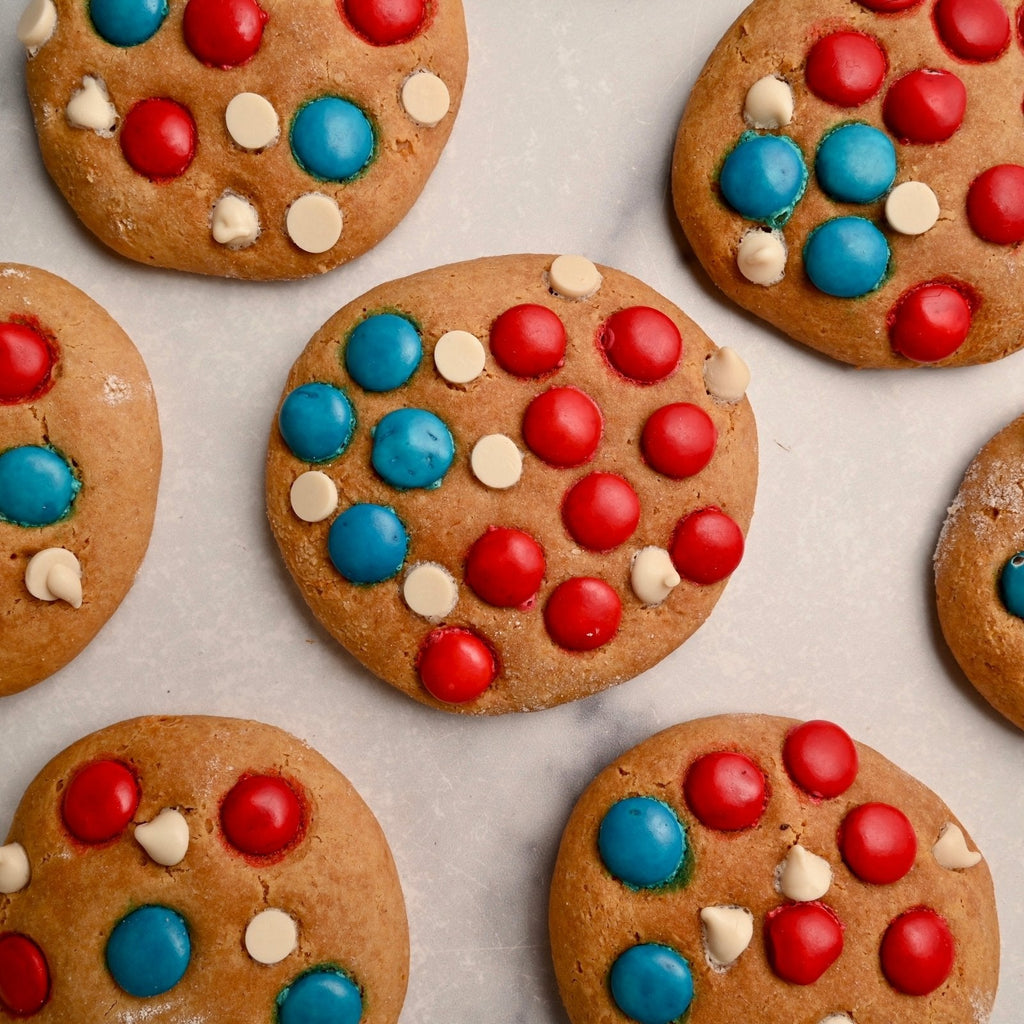 Homemade cookies with red white and blue chocolate candies on top of them