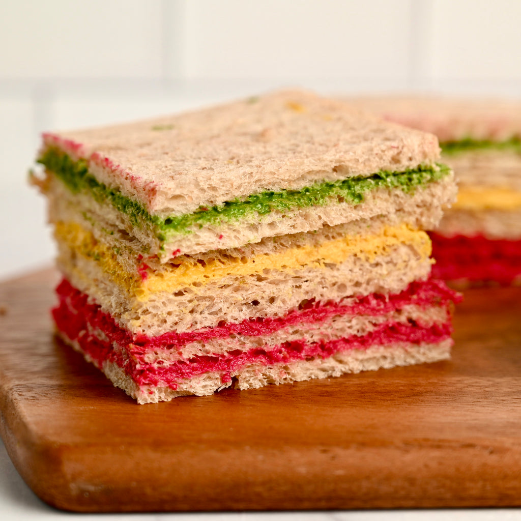A stacked sandwich with rainbow filling