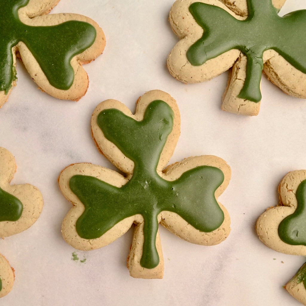 Sugar cookies shaped as shamrock with green frosting