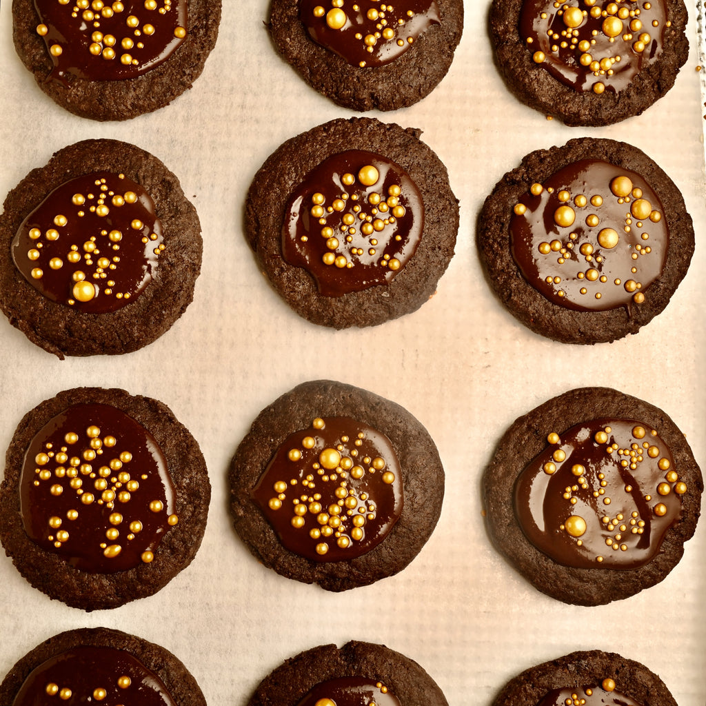 Chocolate cookies with gold sprinkles in the middle