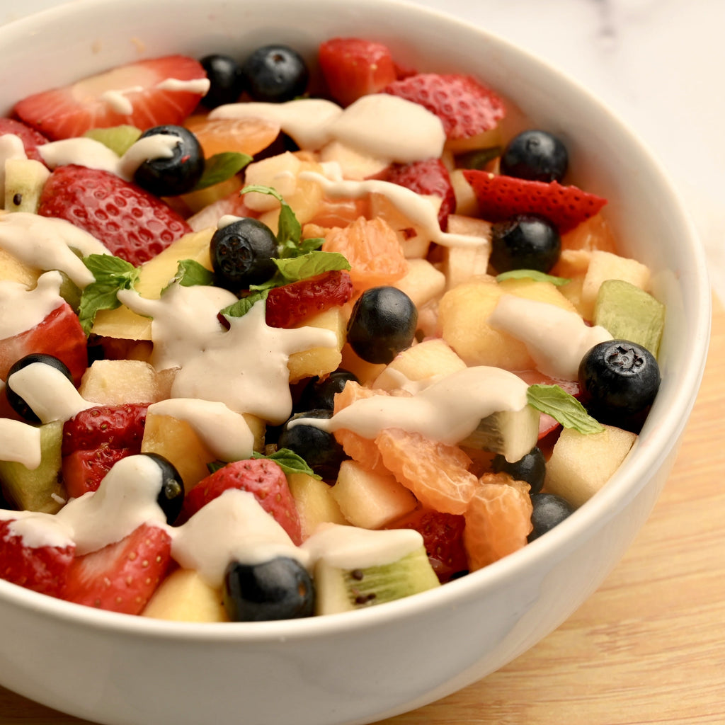 A big ceramic bowl filled with a fresh fruit salad