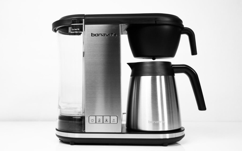 Stainless steel Enthusiast coffee brewer sits on front of a white background.