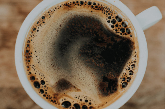 Top profile picture of a fresh cup of coffee.