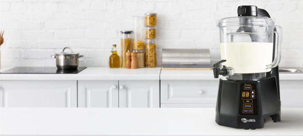 The Nutramilk processor sitting on a counter in a bright white kitchen.