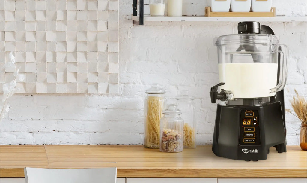 The Nutramilk sits on a wooden counter in a modern kitchen.